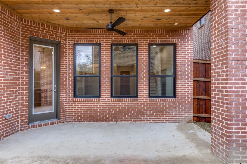 7139 Brisa Drive Dallas, TX 75223 - Photo 26 of 27 a view of a brick house with large windows