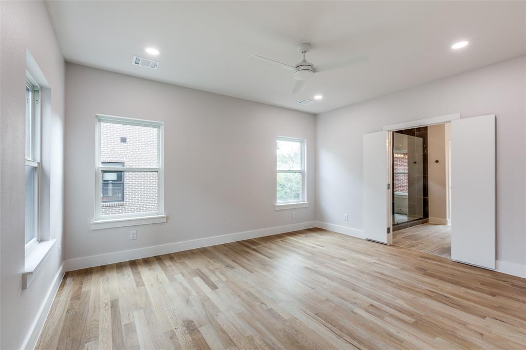 7139 Brisa Drive Dallas, TX 75223 - Photo 10 of 27 a view of an empty room with wooden floor and a window