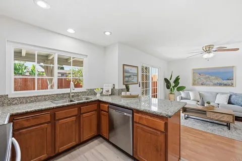 a kitchen with granite countertop cabinets sink and window