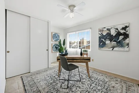 a workspace room with furniture and a potted plant
