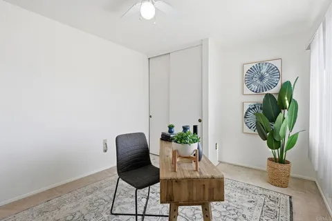 a living room with furniture and a potted plant