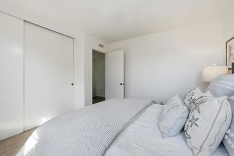 a bedroom with a bed and a night stand