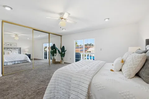 a bedroom with a large bed and a chandelier