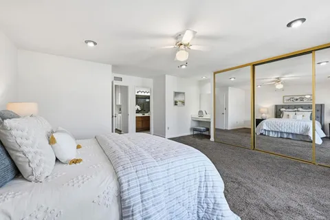 a bedroom with a bed and a large mirror