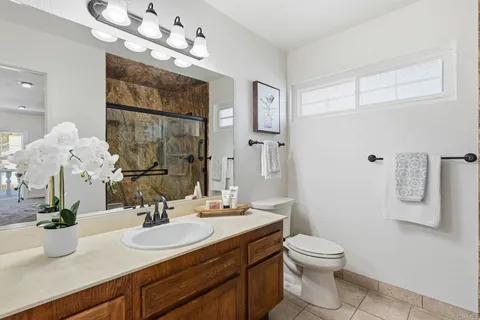 a bathroom with a sink a toilet and a mirror