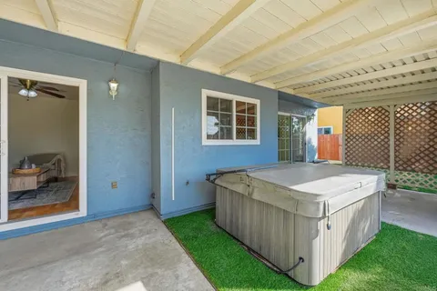 a spacious bedroom with a table and flat screen tv