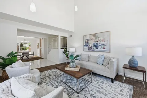 a living room with furniture potted plant and a window