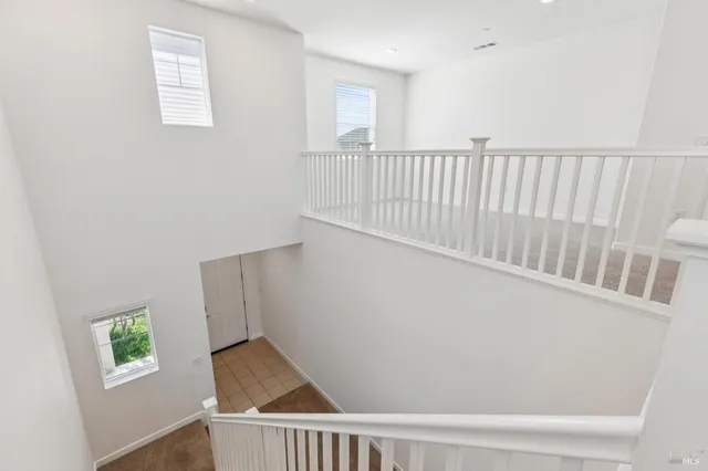 a view of a hallway with wooden floor and a window