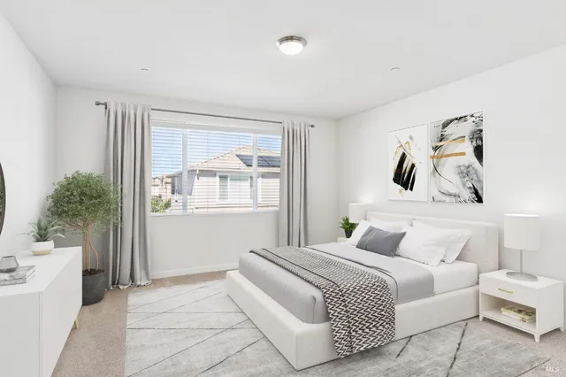 a bedroom with a bed and a painting on the wall