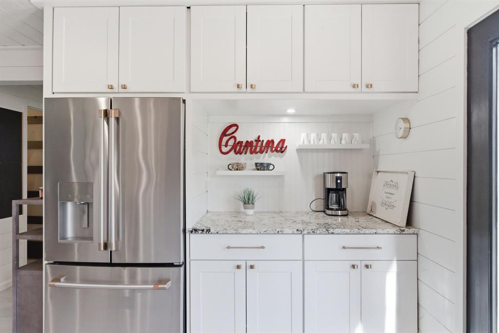 5206 Wedgefield Road Granbury, TX 76049 - Photo 12 of 39 a kitchen with refrigerator and cabinets