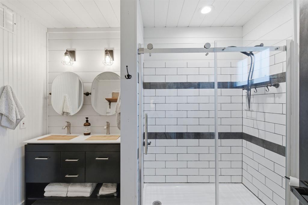 5206 Wedgefield Road Granbury, TX 76049 - Photo 18 of 39 a bathroom with a sink shower and a mirror