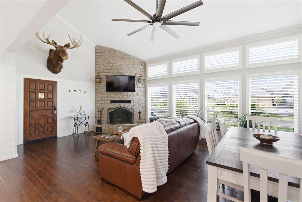 5206 Wedgefield Road Granbury, TX 76049 - Photo 3 of 39 a living room with furniture a fireplace and a flat screen tv