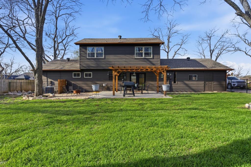 5206 Wedgefield Road Granbury, TX 76049 - Photo 32 of 39 a front view of a house with a yard table and chairs