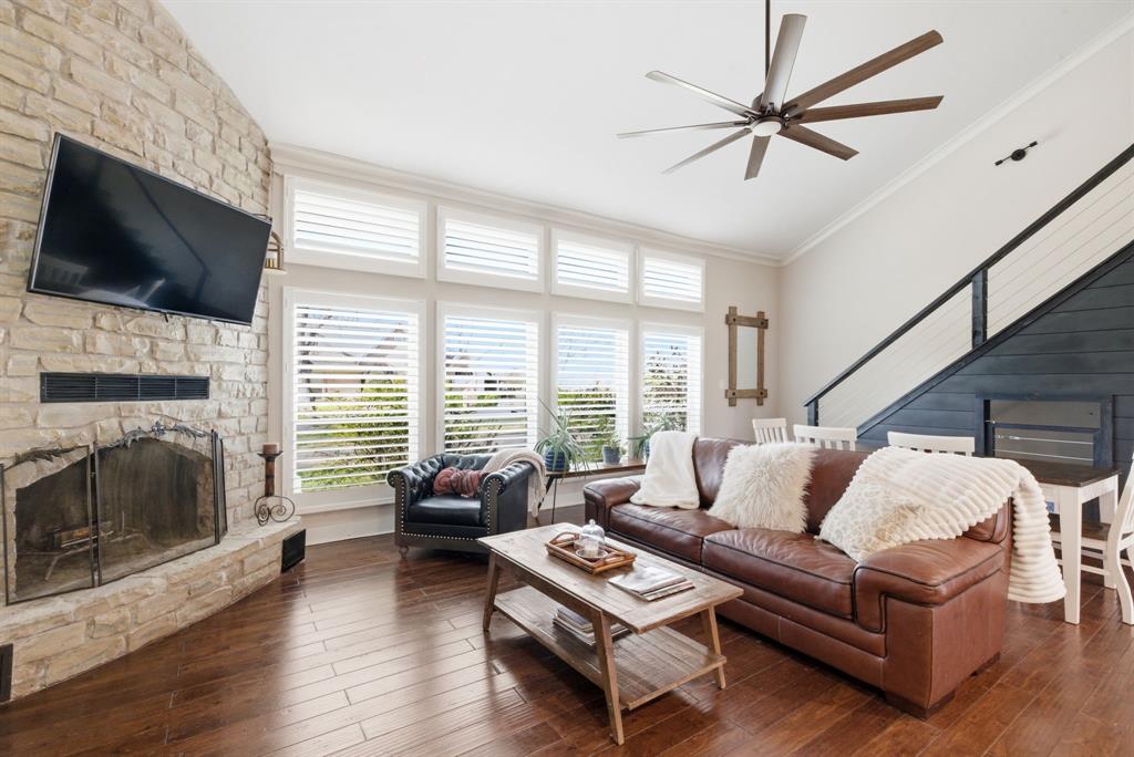 5206 Wedgefield Road Granbury, TX 76049 - Photo 4 of 39 a living room with furniture a flat screen tv and a fireplace