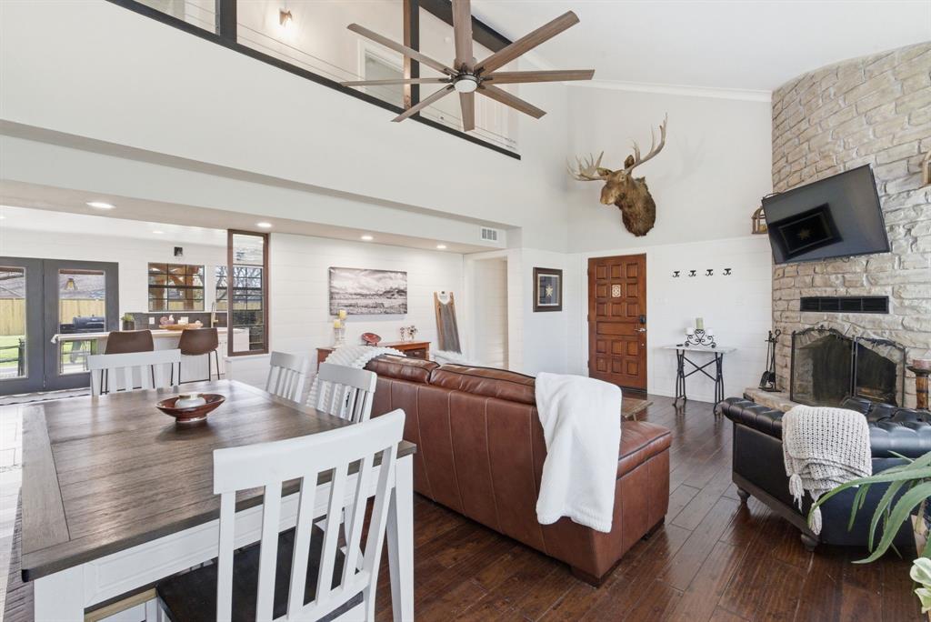 5206 Wedgefield Road Granbury, TX 76049 - Photo 6 of 39 a living room with furniture a fireplace and a flat screen tv