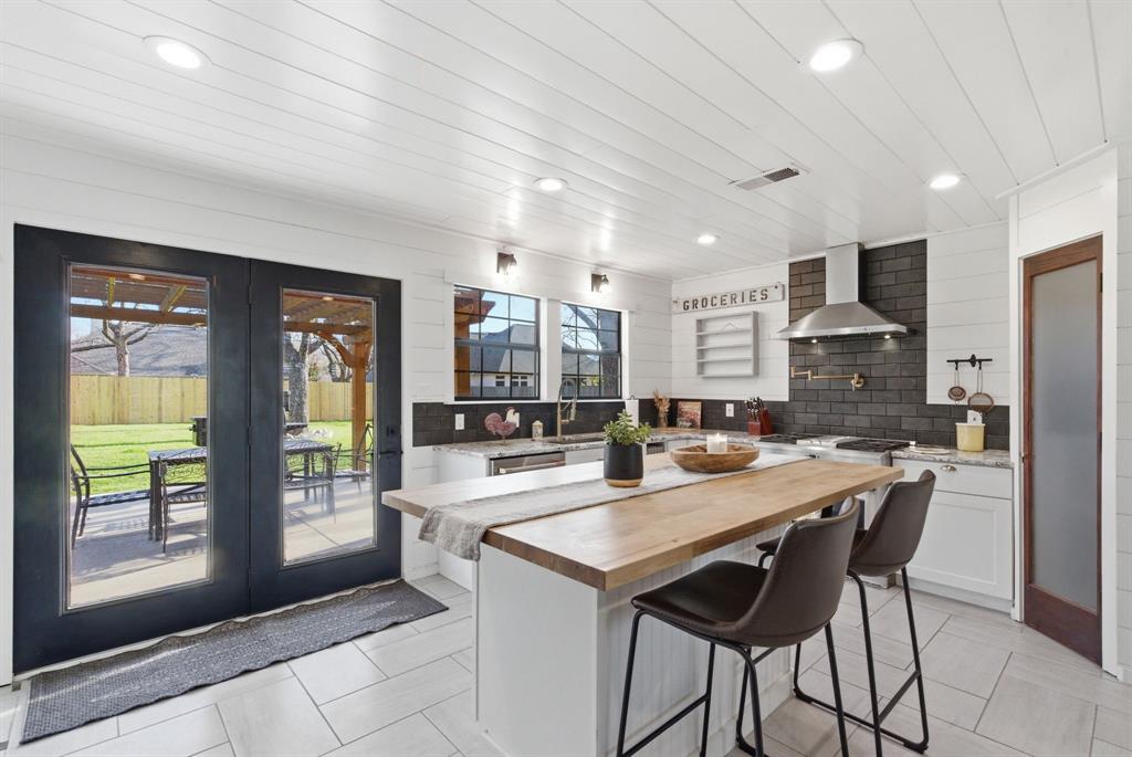 5206 Wedgefield Road Granbury, TX 76049 - Photo 8 of 39 a dining hall with stainless steel appliances granite countertop a stove and a refrigerator