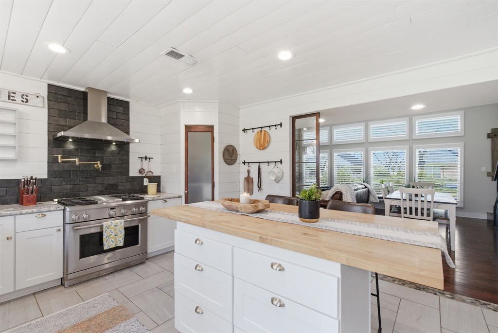 5206 Wedgefield Road Granbury, TX 76049 - Photo 9 of 39 a kitchen with stove a sink and cabinets