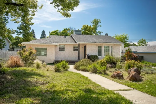 a aerial view of a house with a yard and potted plants