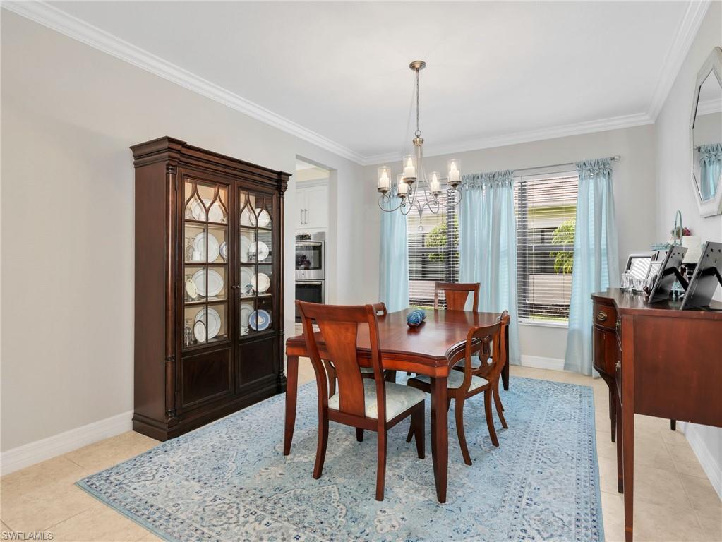 2756 Crystal Way Naples, FL 34119 - Photo 16 of 50 a view of a dining room with furniture window and wooden floor