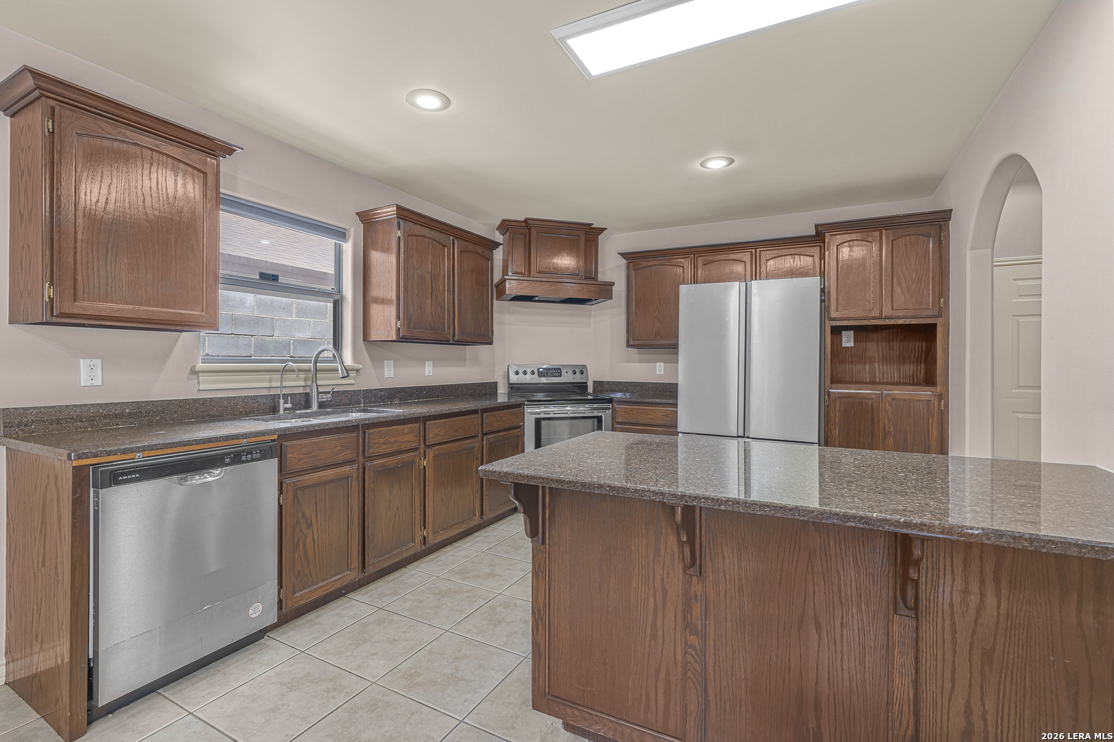 8710 Allegheny Laredo, TX 78045 - Photo 11 of 23 a kitchen with stainless steel appliances granite countertop a refrigerator a sink and wooden cabinets