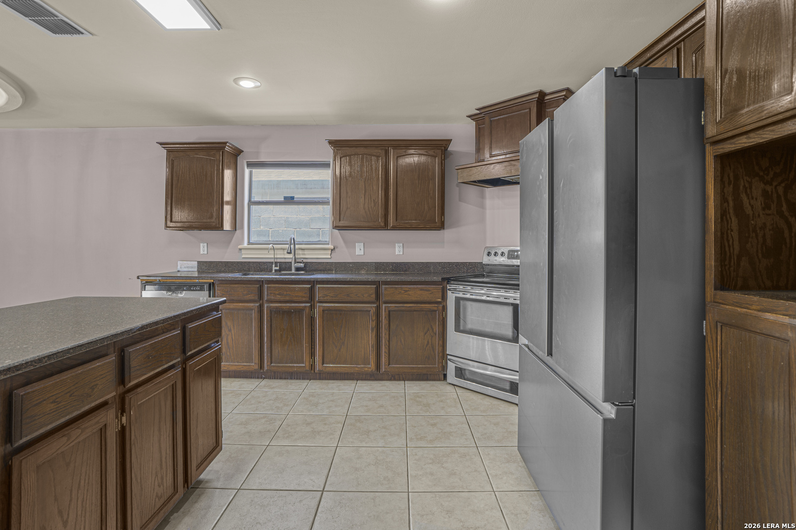8710 Allegheny Laredo, TX 78045 - Photo 13 of 23 a kitchen with a sink stove and refrigerator