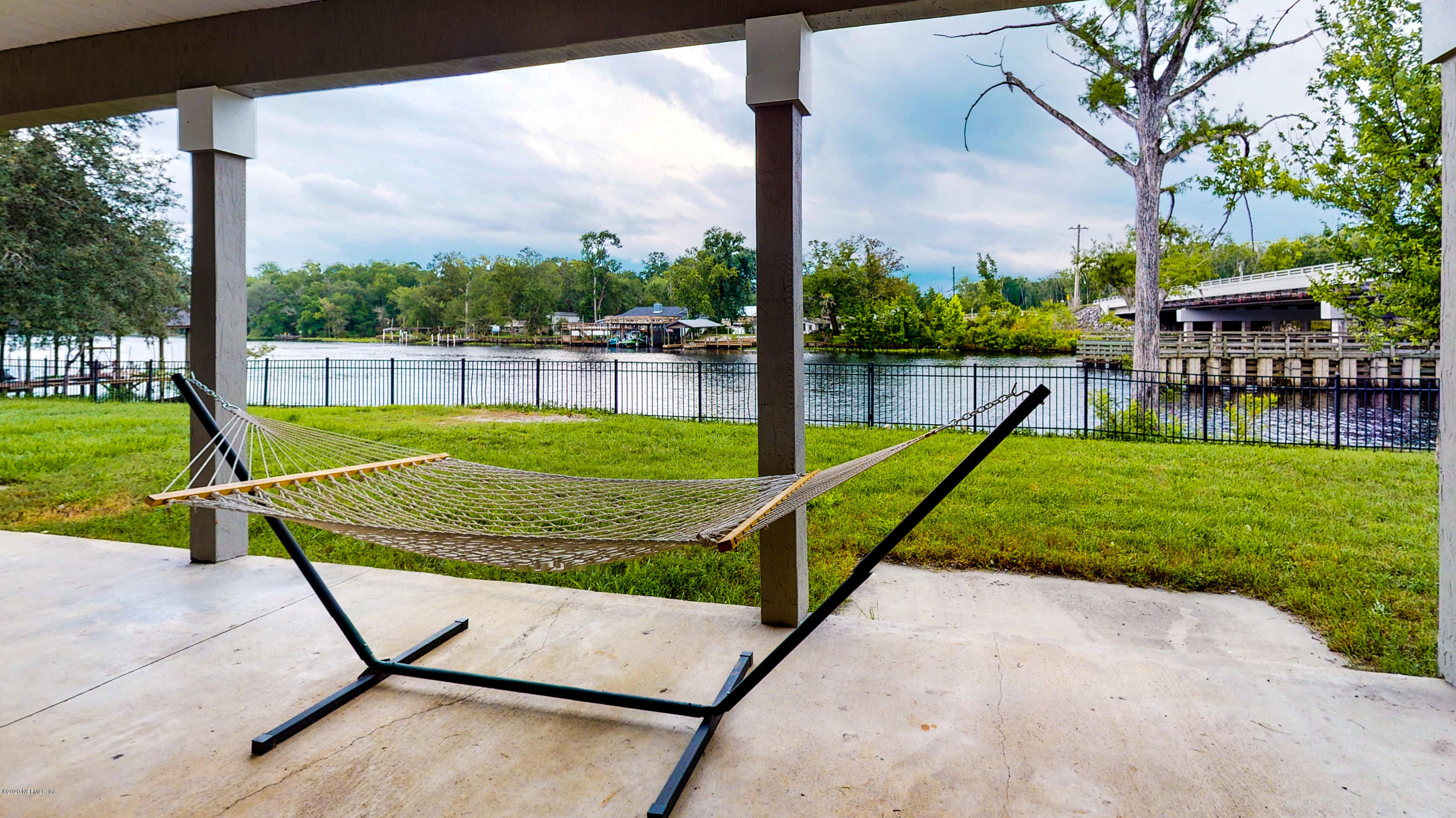a view of a swimming pool with a patio and a yard
