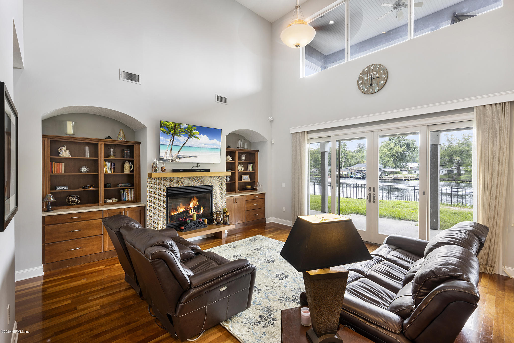 3255 Manatee Point Middleburg, FL 32068 - Photo 14 of 70 a living room with furniture a fireplace and a large window with garden view