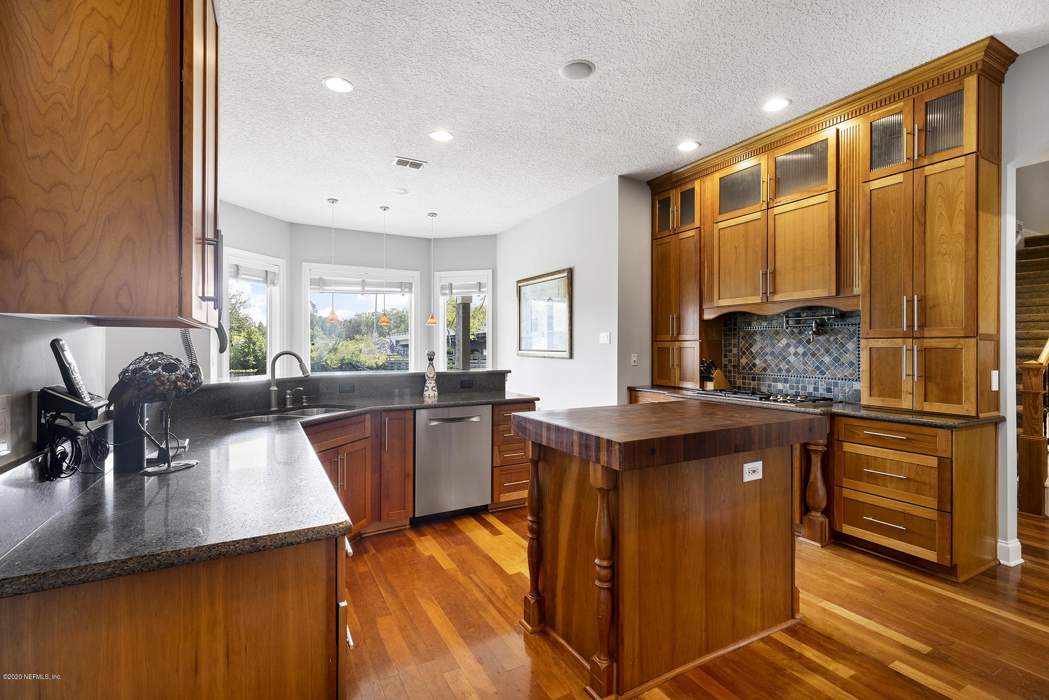 3255 Manatee Point Middleburg, FL 32068 - Photo 21 of 70 a kitchen with stainless steel appliances granite countertop sink stove and refrigerator