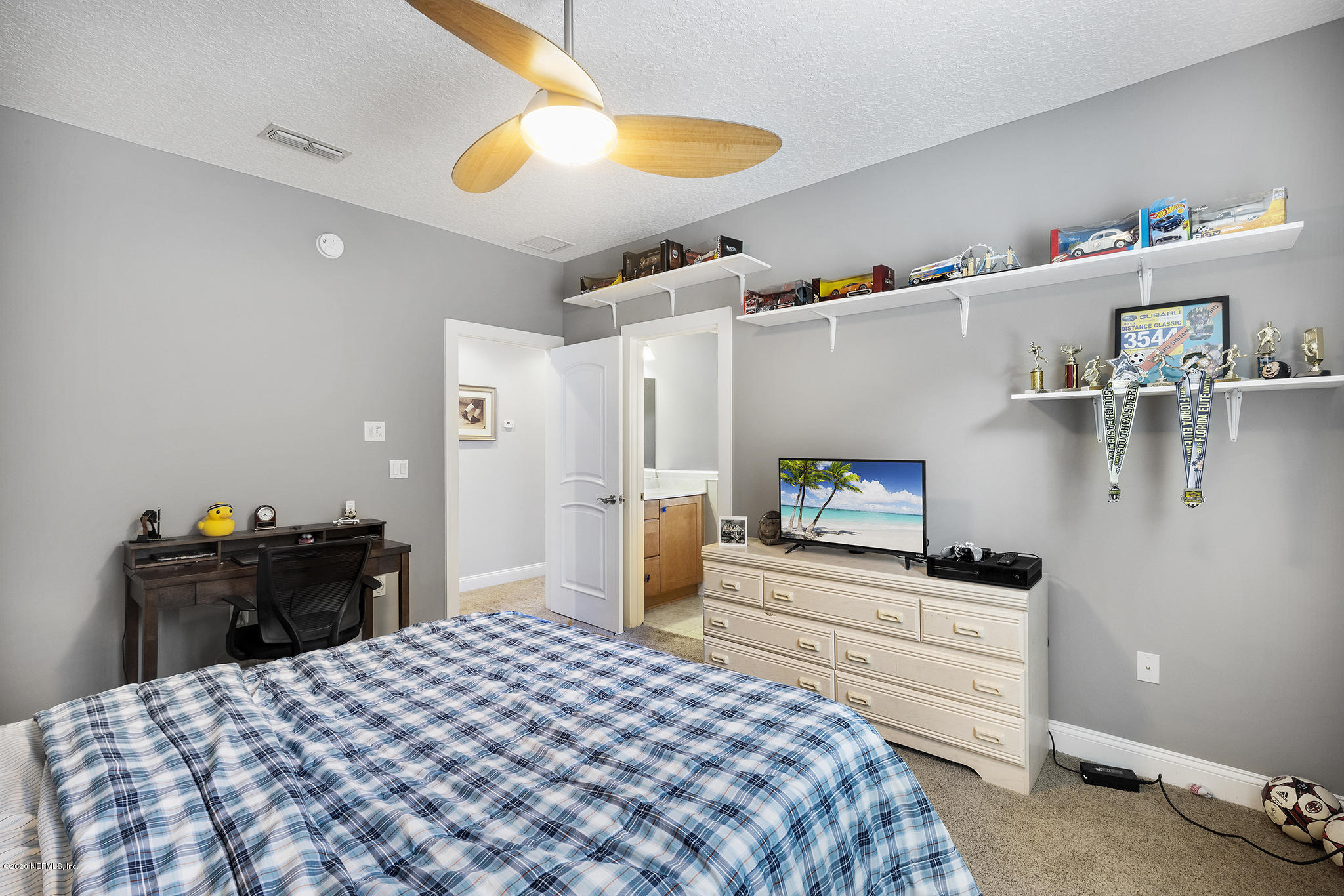 3255 Manatee Point Middleburg, FL 32068 - Photo 45 of 70 a bedroom with a bed and a chandelier