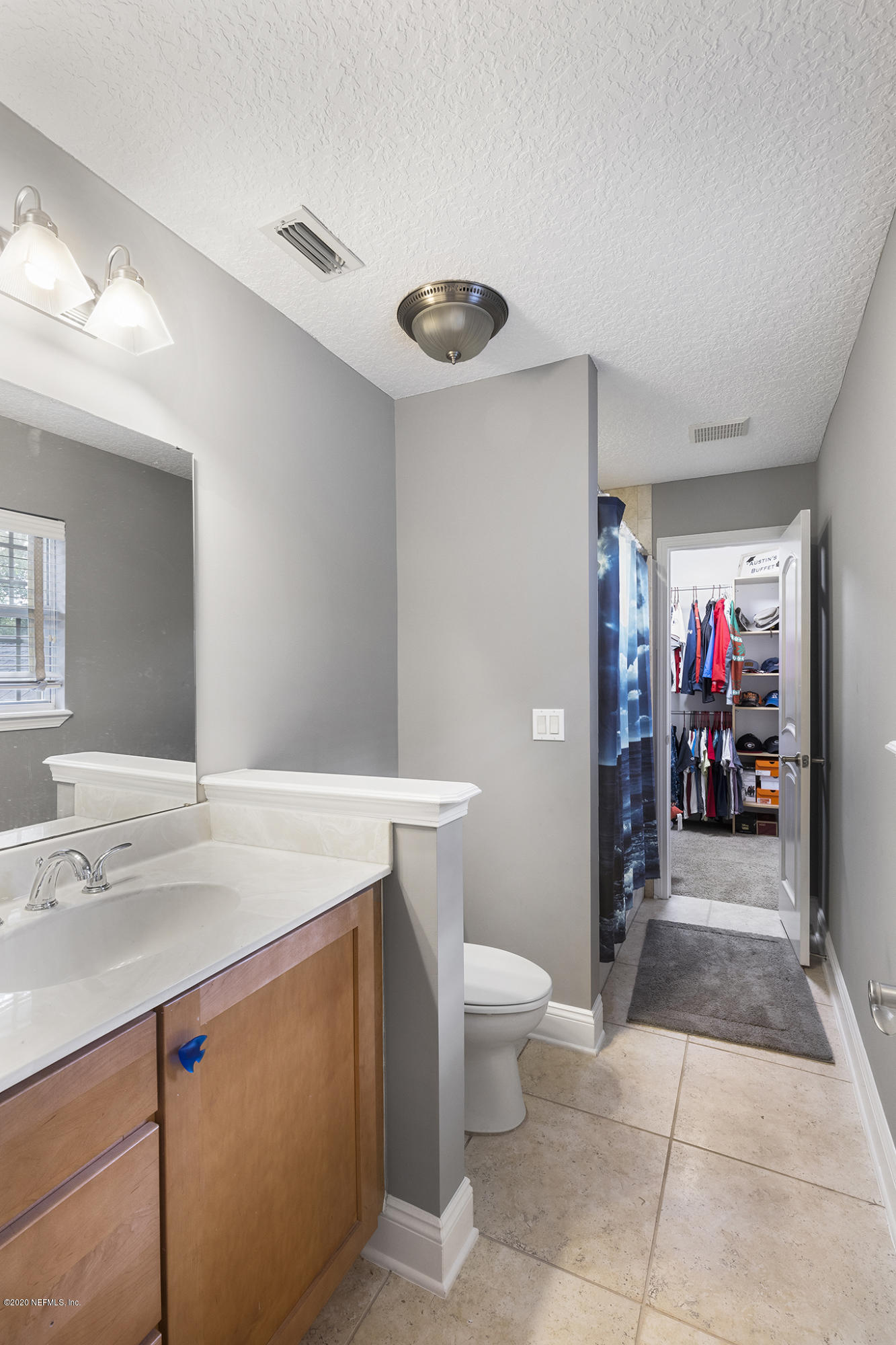 3255 Manatee Point Middleburg, FL 32068 - Photo 48 of 70 a view of a bathroom with a sink and a mirror