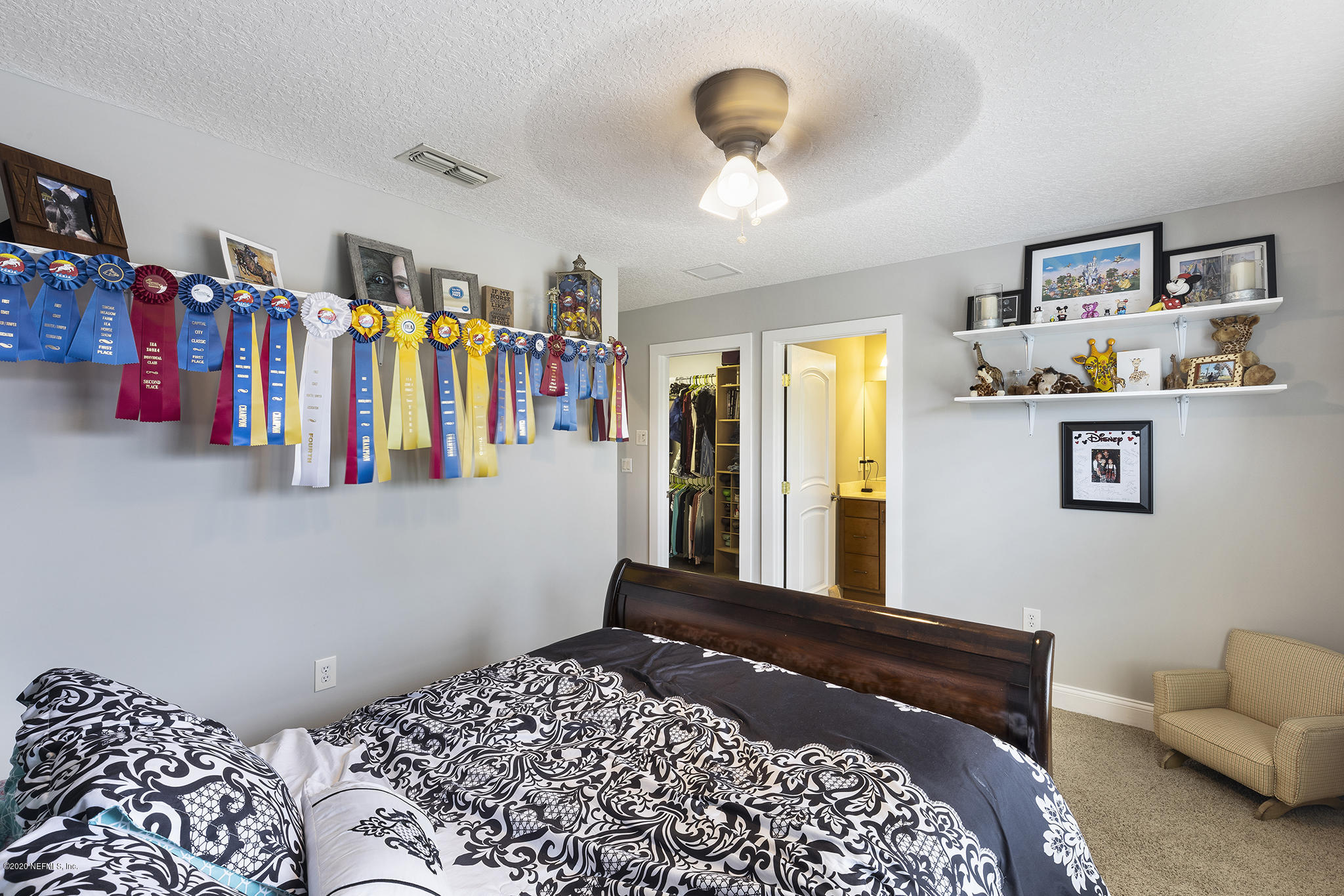 3255 Manatee Point Middleburg, FL 32068 - Photo 50 of 70 a bedroom with a bed painting on the wall and a window