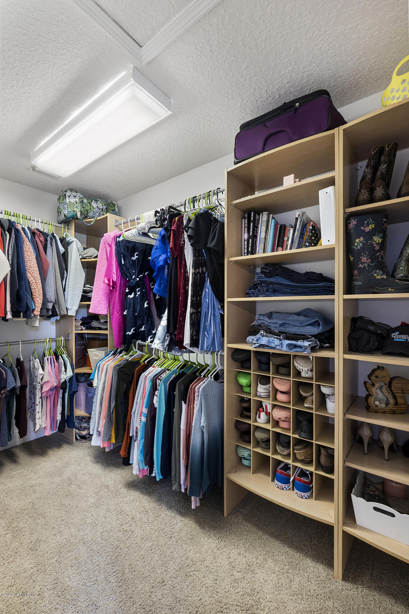 3255 Manatee Point Middleburg, FL 32068 - Photo 53 of 70 a view of walk in closet with clothes and shoes