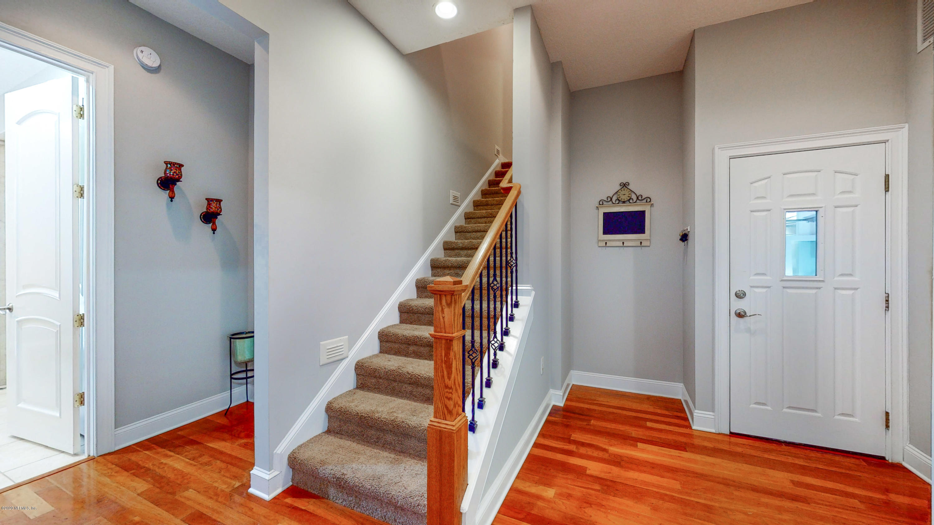 3255 Manatee Point Middleburg, FL 32068 - Photo 56 of 70 a view of an entryway with wooden floor and staircase