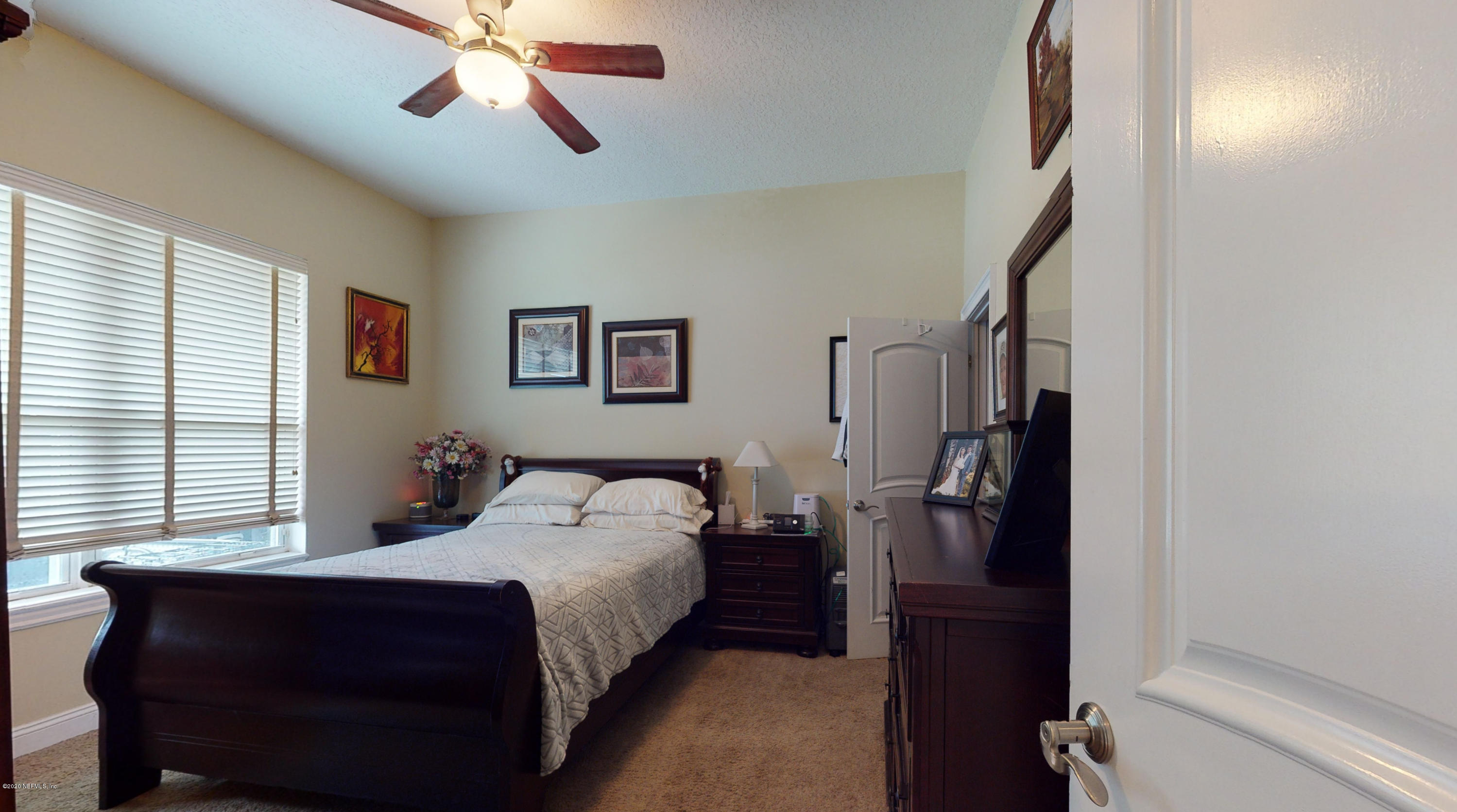 3255 Manatee Point Middleburg, FL 32068 - Photo 57 of 70 a bedroom with a bed and a chandelier