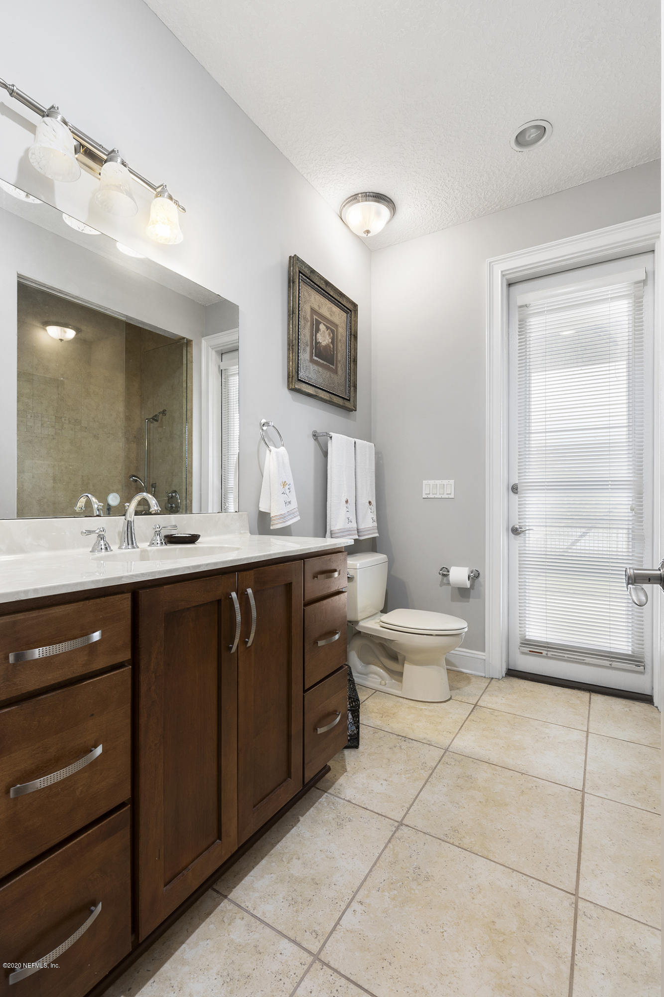 3255 Manatee Point Middleburg, FL 32068 - Photo 59 of 70 a bathroom with a double vanity sink a mirror and a bathtub