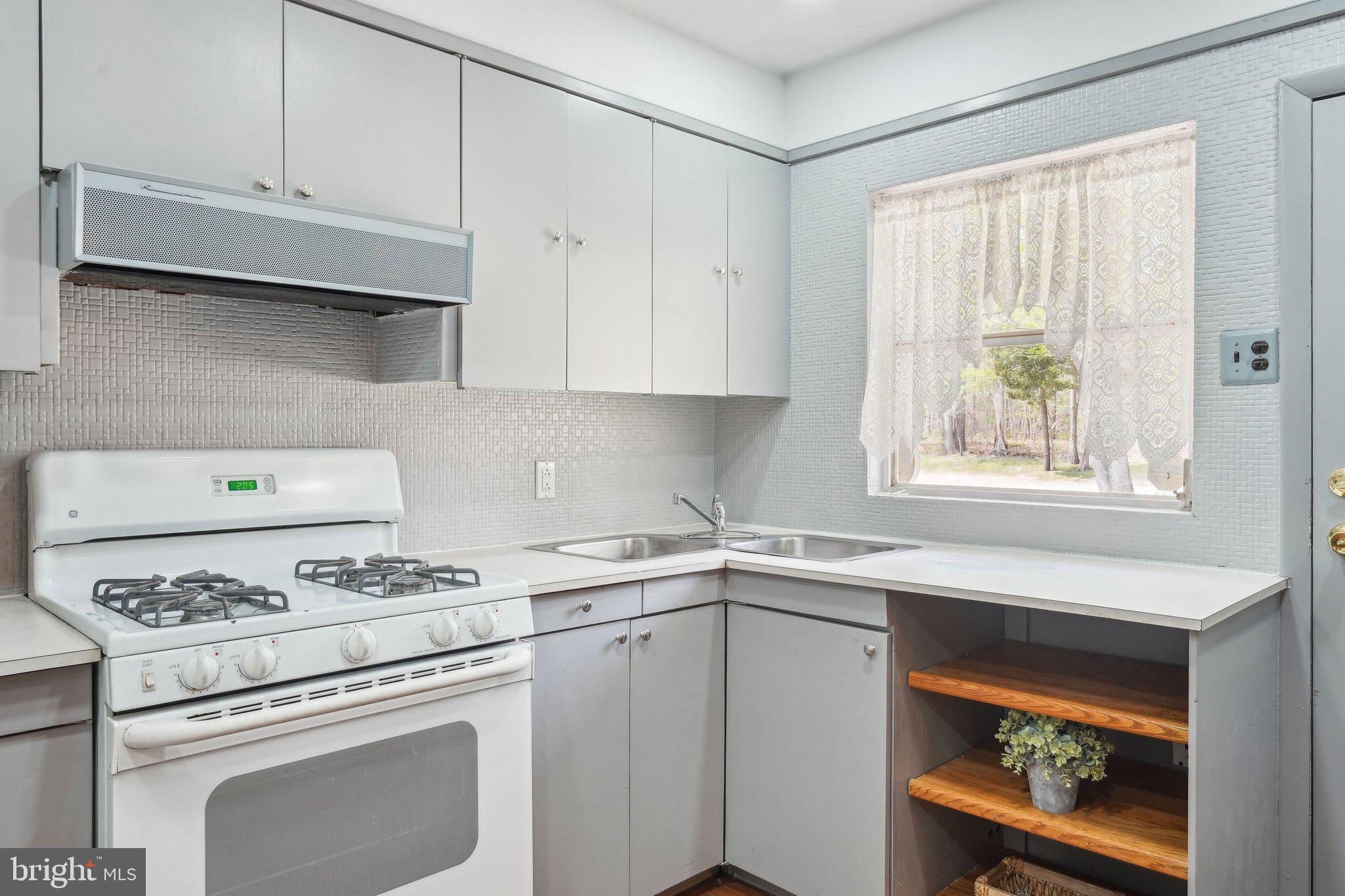 2 Oakview Drive Berlin, NJ 08009 - Photo 16 of 64 a kitchen with granite countertop cabinets stainless steel appliances and a window