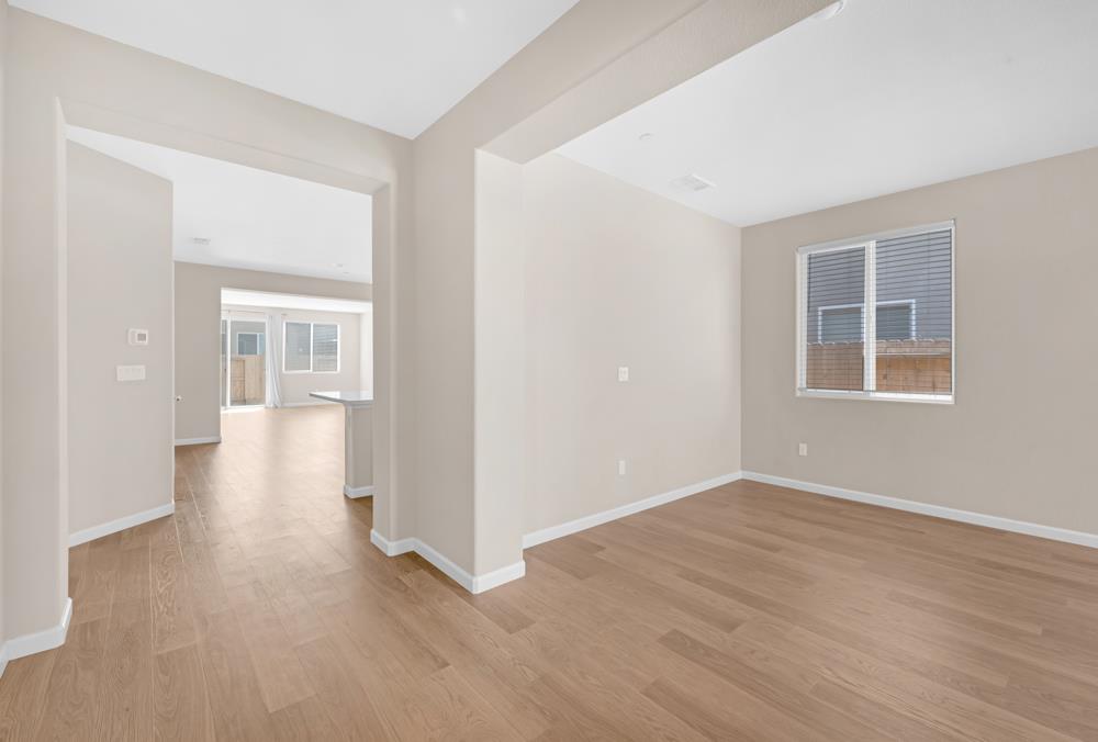 542 Legado Drive Soledad, CA 93960 - Photo 11 of 28 a view of an empty room with wooden floor and a window
