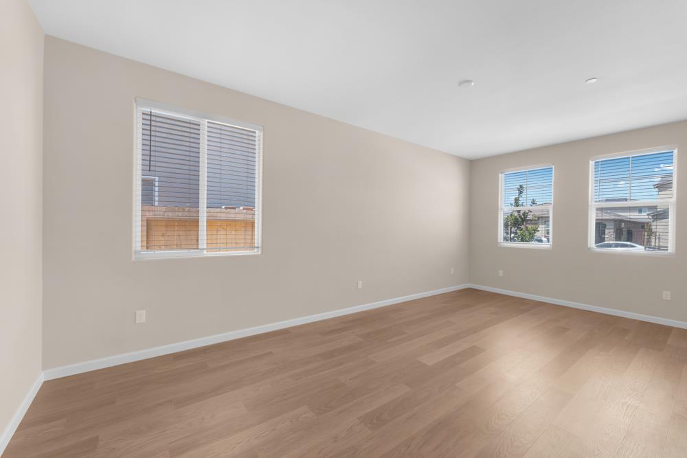 542 Legado Drive Soledad, CA 93960 - Photo 12 of 28 a view of an empty room with wooden floor and a window