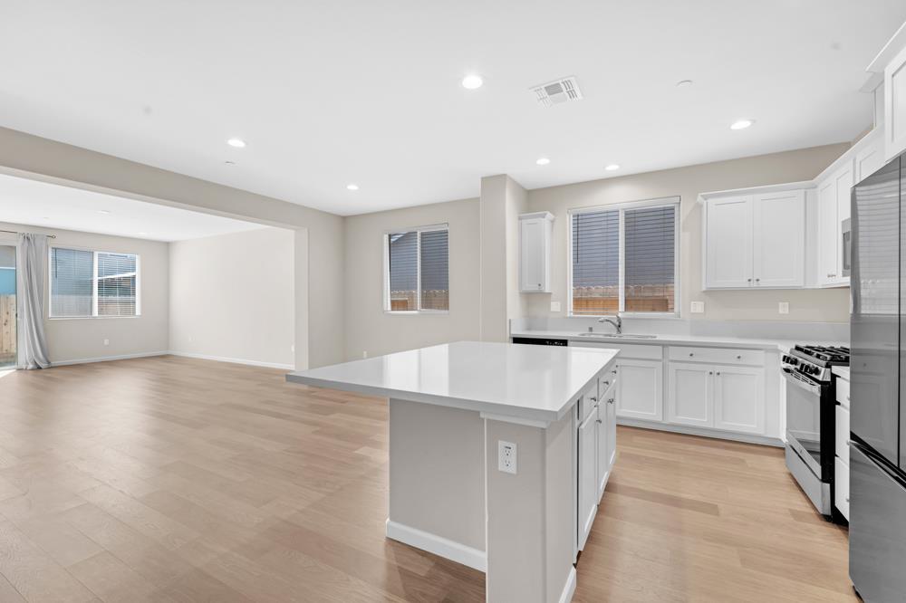 542 Legado Drive Soledad, CA 93960 - Photo 7 of 28 a kitchen with a sink stove and cabinets