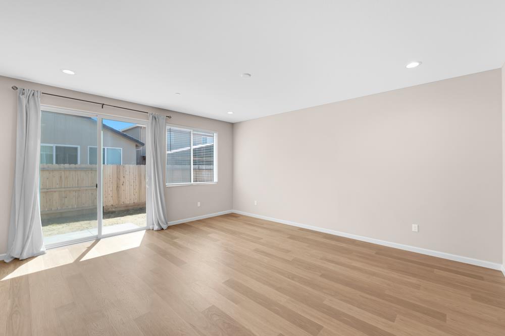 542 Legado Drive Soledad, CA 93960 - Photo 8 of 28 an empty room with wooden floor and windows