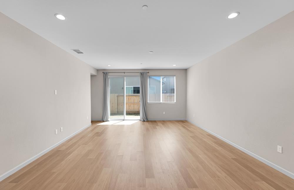 542 Legado Drive Soledad, CA 93960 - Photo 10 of 28 an empty room with wooden floor and windows