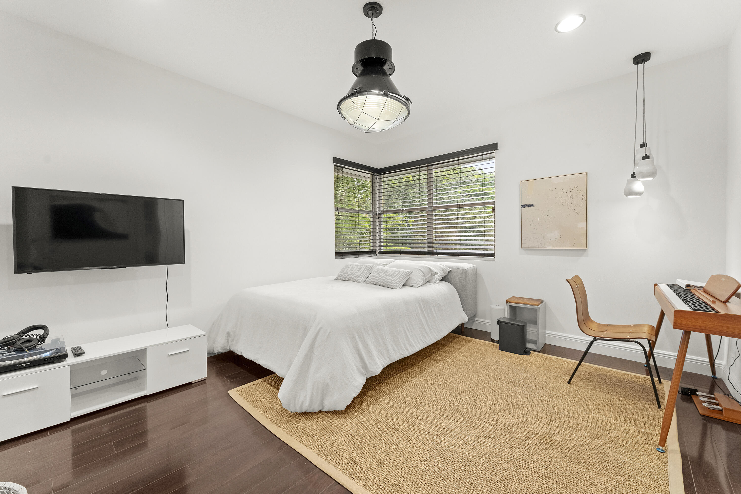 3156 Northwest 61st Street Boca Raton, FL 33496 - Photo 33 of 46 a bedroom with a bed and a flat screen tv