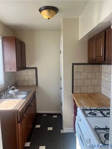 a kitchen that has a sink and a stove
