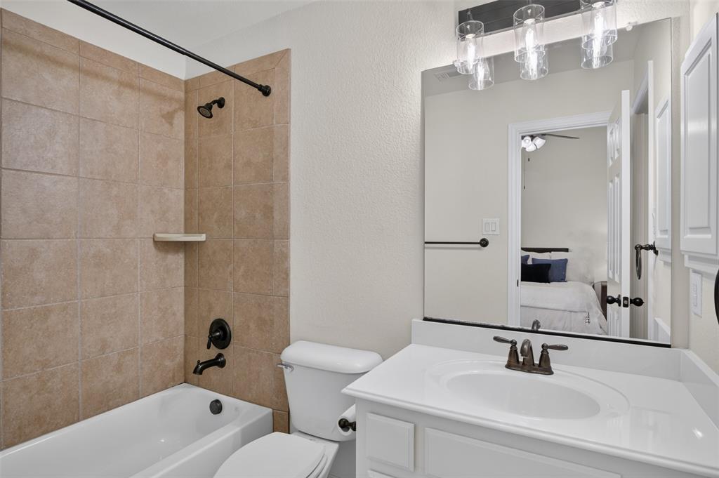 842 Sun Meadow Road Allen, TX 75013 - Photo 25 of 39 Full bathroom featuring a white vanity with integrated sink, bronze-finish faucet, and a large wall-mounted mirror