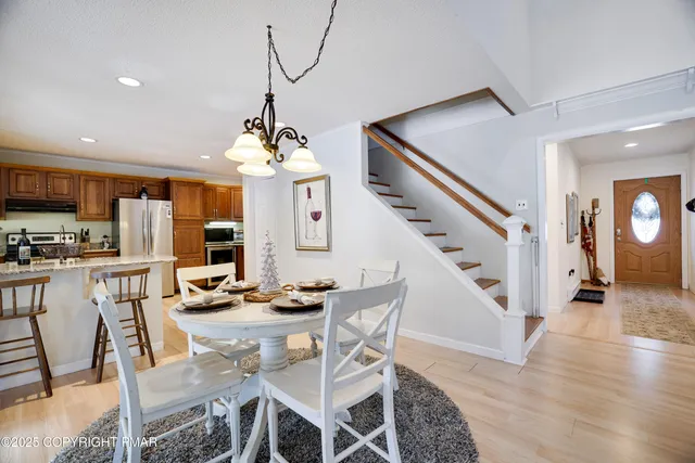 a bathroom with a toilet sink vanity and mirror