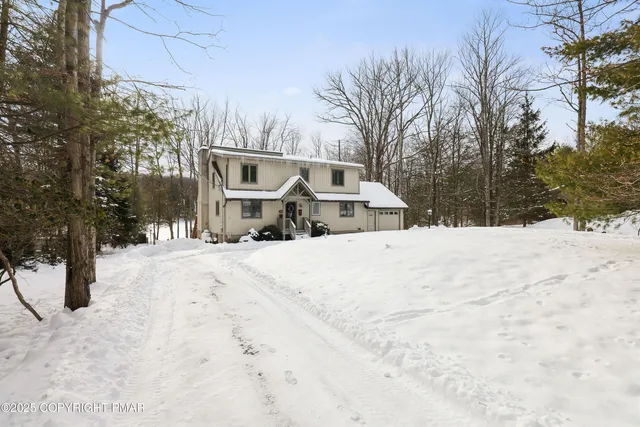 a view of a white building with large windows