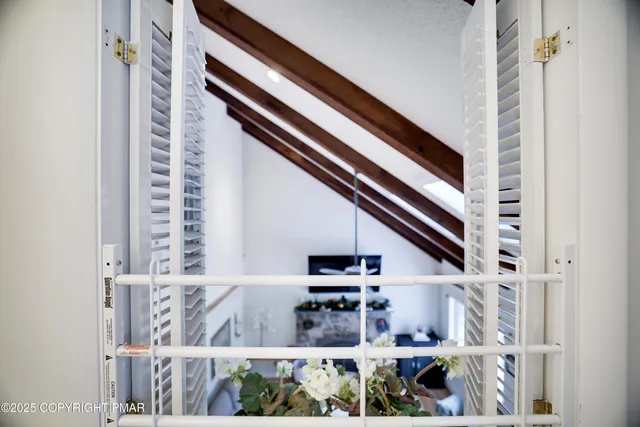 a bedroom with a large bed and painting on the wall