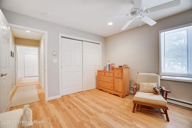 a bedroom with a bed and dresser with mirror