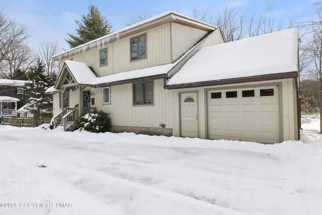 a view of a dining room with furniture a chandelier and wooden floor