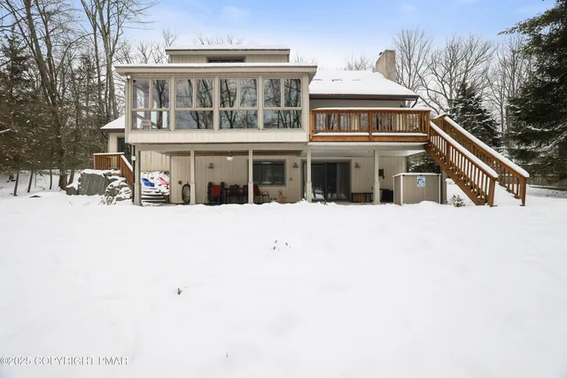 a dining room with furniture a chandelier and wooden floor